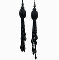 Pair of black beaded tassel earrings on a white background