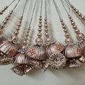 Decorative necklaces with floral and bead designs on a light background