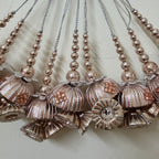 Decorative necklaces with floral and bead designs on a light background