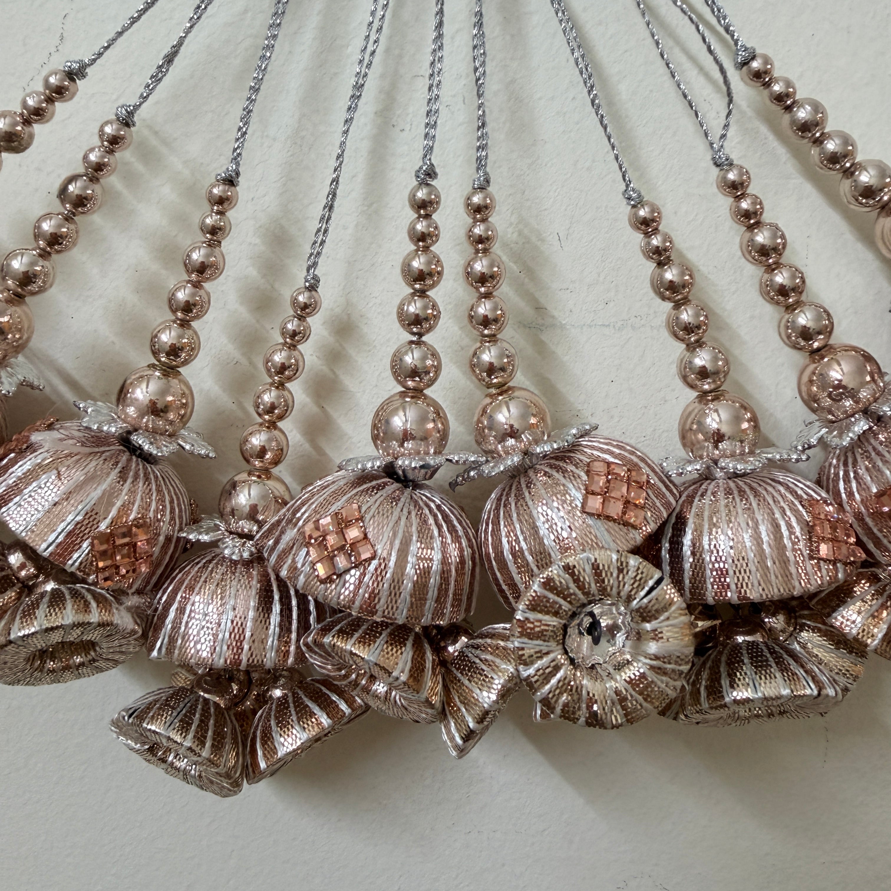 Decorative necklaces with floral and bead designs on a light background