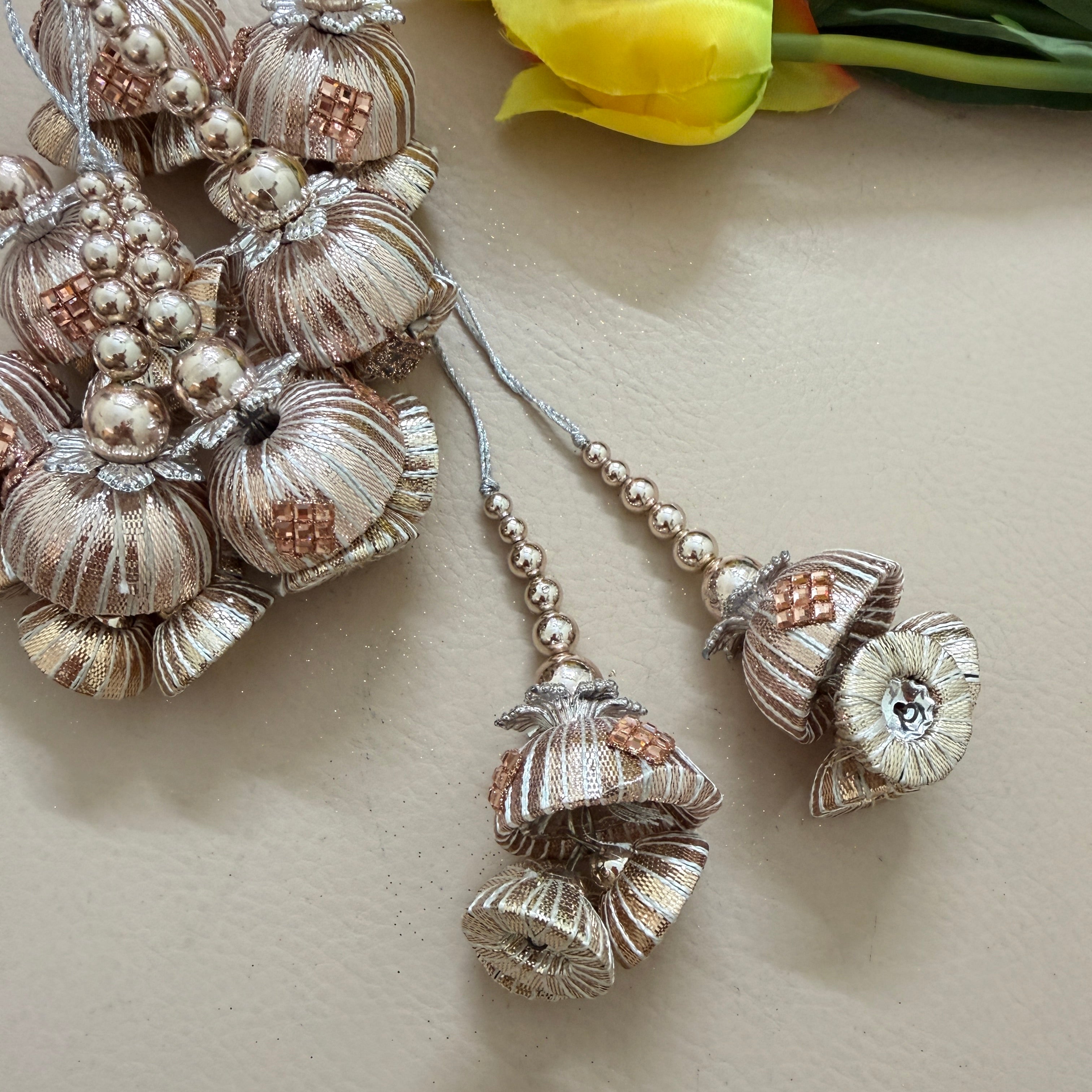 Decorative earrings with floral designs on a light surface.