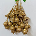 Decorative gold chandelier with hanging beads on a white background
