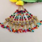 Colorful beaded tassel necklace with gold accents on a light background