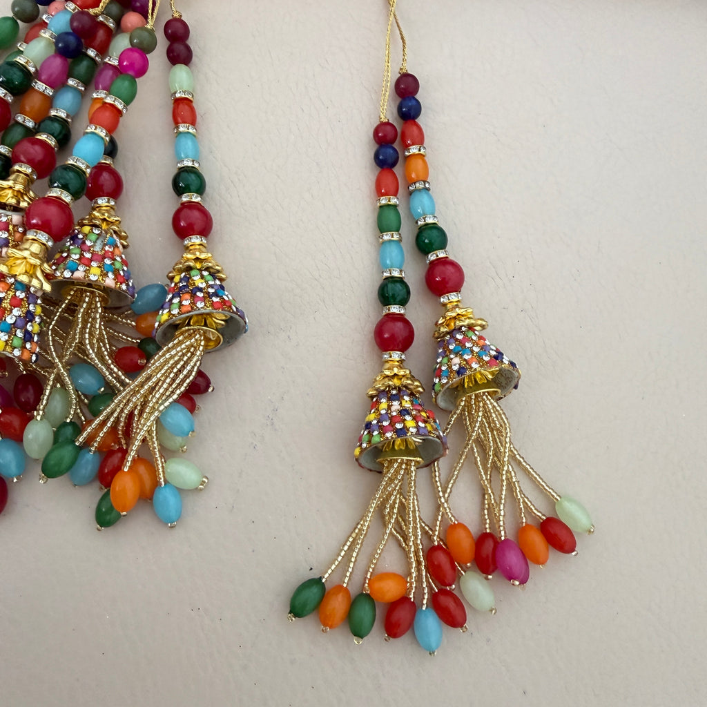 Colorful beaded earrings with gold accents on a light background