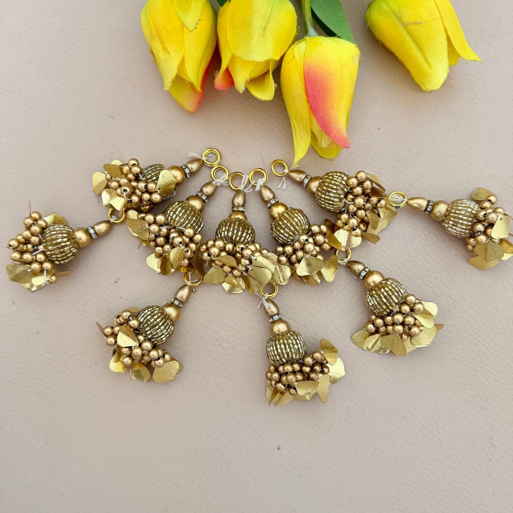 Gold jewelry set with yellow tulips on a light background