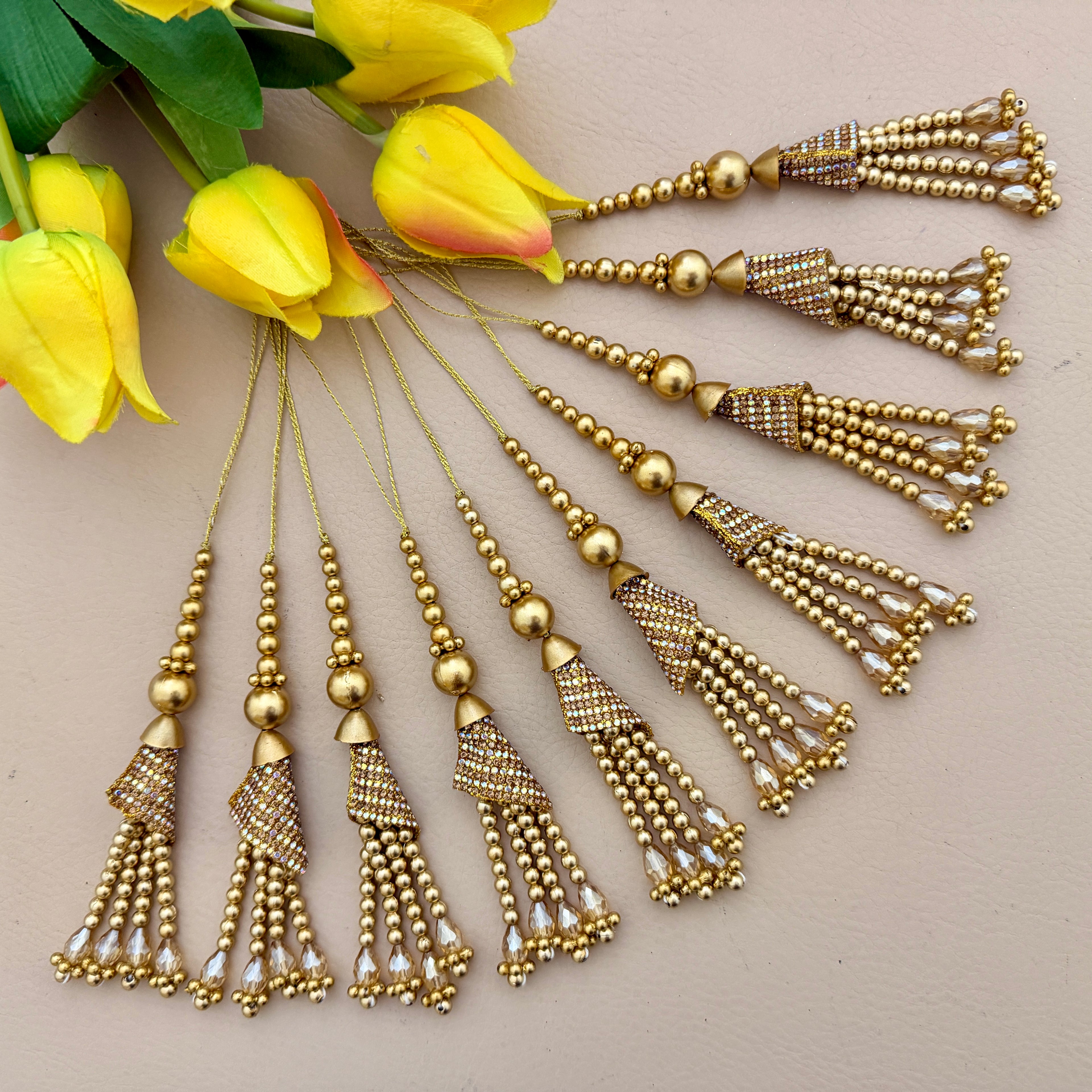 Gold tassels with floral background