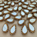 Pair of reflective teardrop tassels with sparkling champagne borders