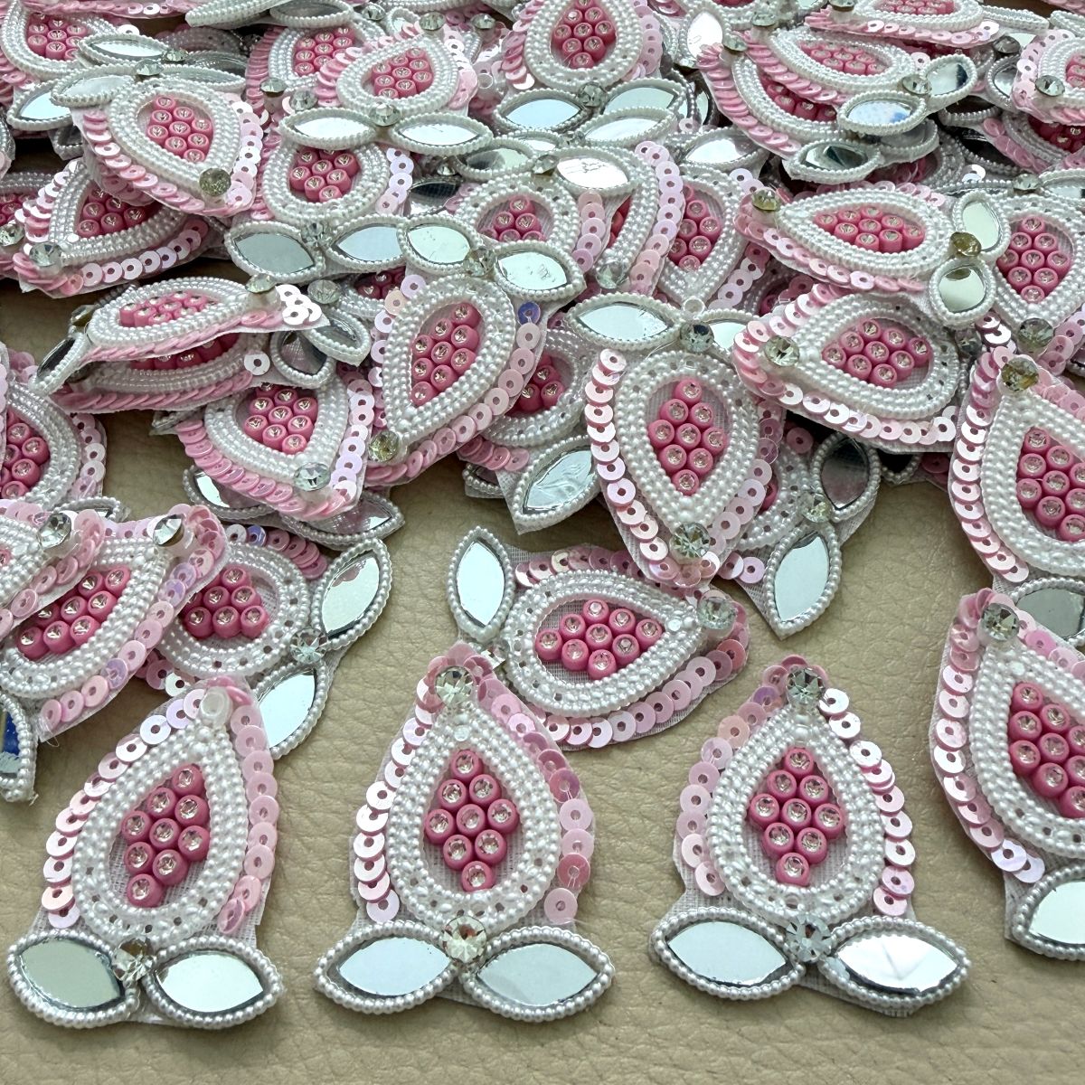 Collection of pink sequin patches with white pearl-look beads and leaf-shaped mirror accents