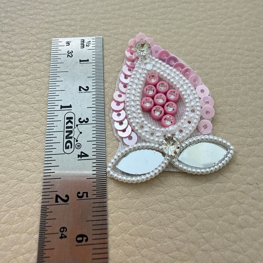 Pink teardrop patch beside ruler showing approximately 4.5 cm length