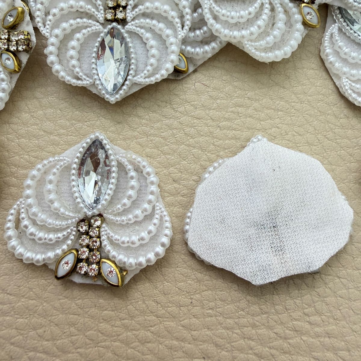 Front detail and white fabric backing of decorative fan patch