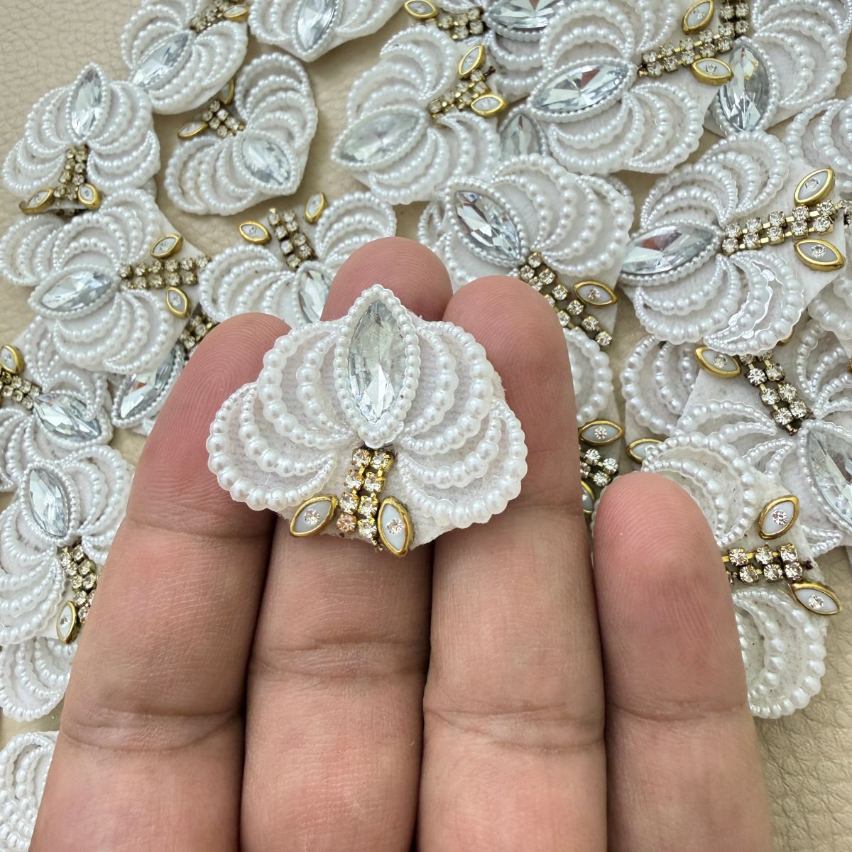 Two white fan-shaped patches with pearl-effect beads, clear marquise stones and gold-tone accents