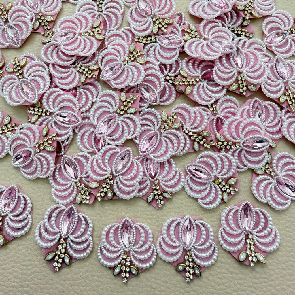 Group of pink fan-shaped patches with white pearl-effect beads and rhinestone details