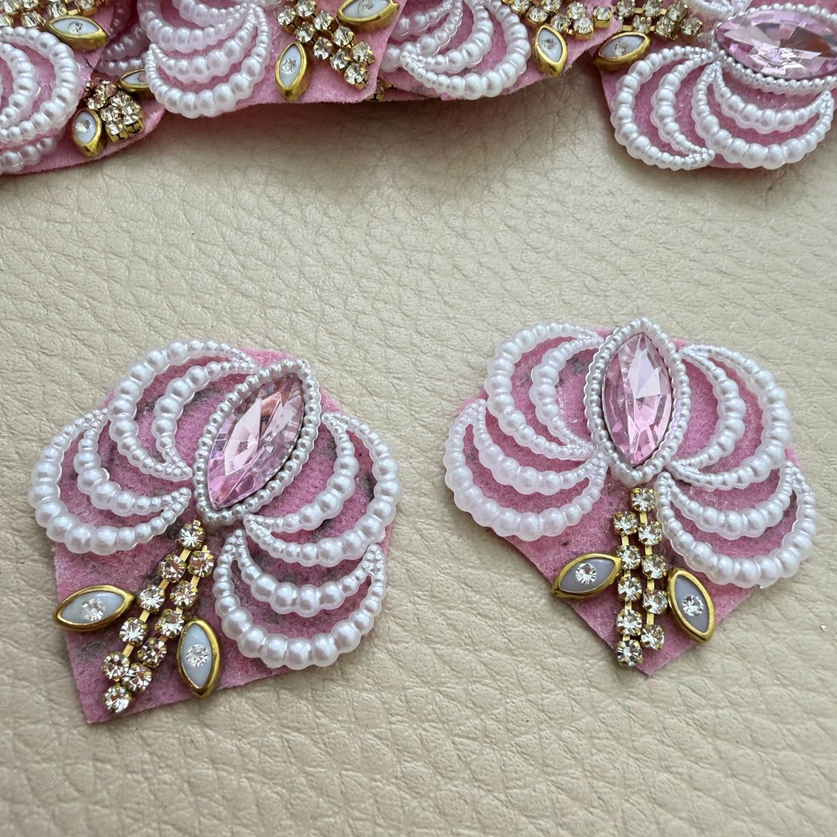 Two pink fan patches with white pearl-effect bead loops, pink marquise stones and gold-tone rhinestone accents