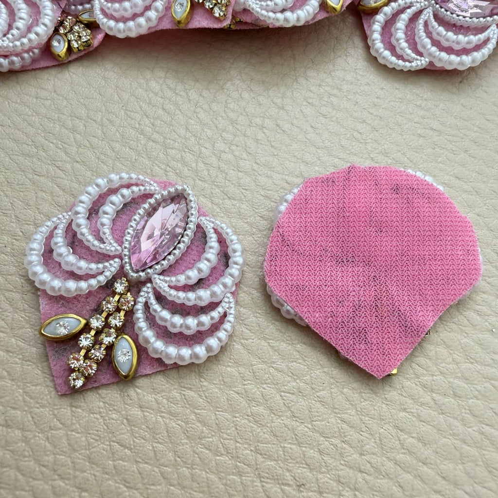 Front detailing and pink fabric backing of a pearl-effect fan patch