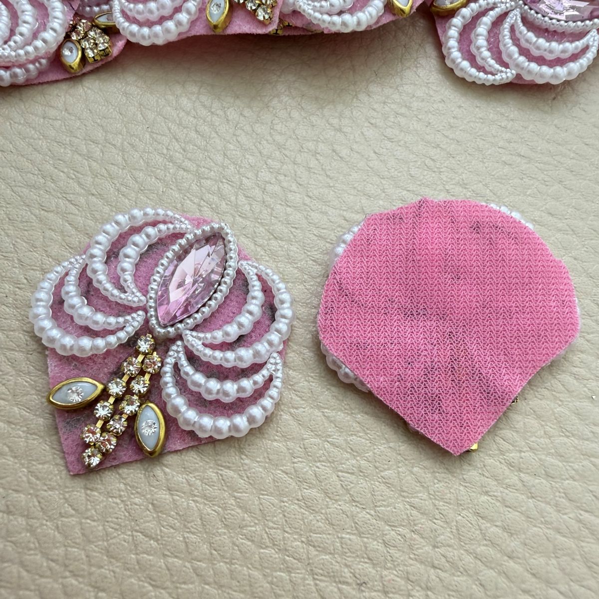 Front detailing and pink fabric backing of a pearl-effect fan patch