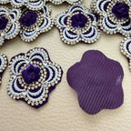 Front decoration and plain purple fabric backing of flower patch