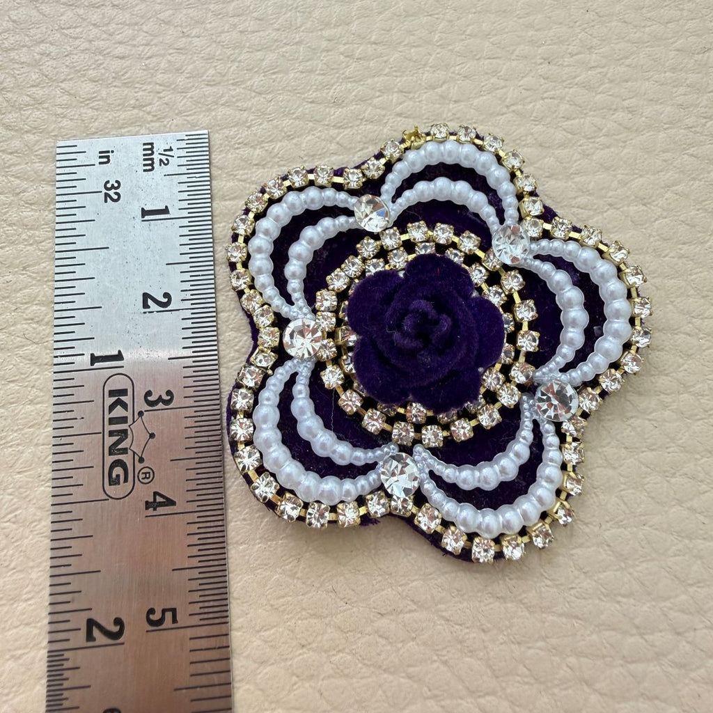 Purple flower patch beside ruler showing approximate 4.5 cm size