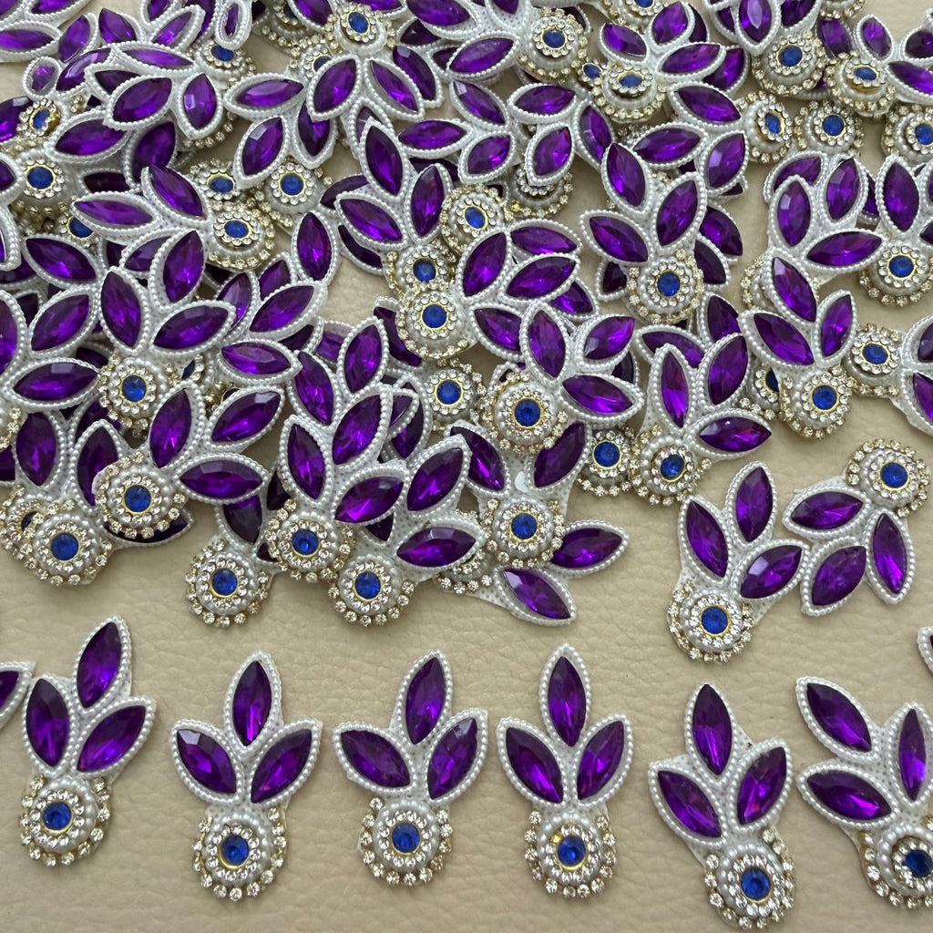 Collection of purple three-leaf patches with blue stone centers and white pearl-look bead outlines