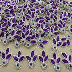 Collection of purple three-leaf patches with blue stone centers and white pearl-look bead outlines