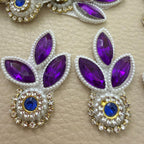Purple leaf and blue stone patch held in hand showing pearl-look beads and clear stone detailing