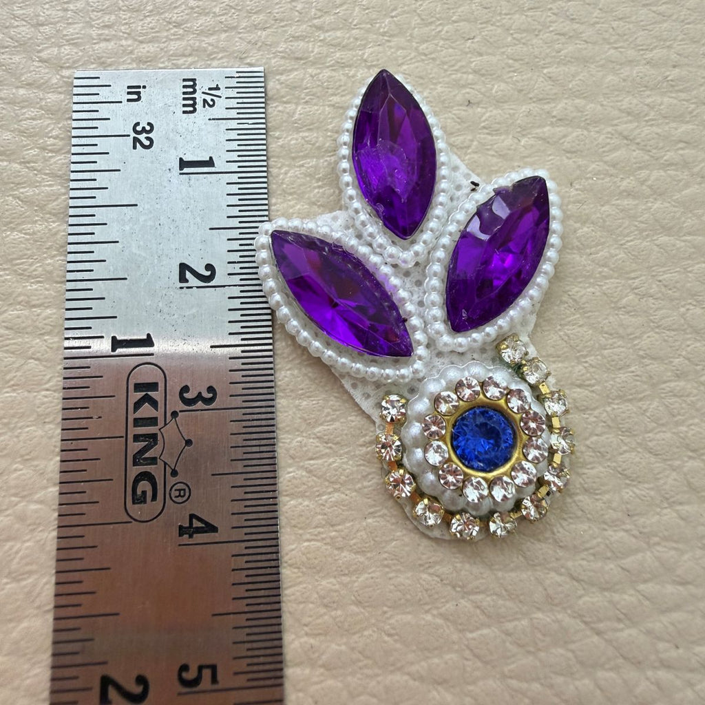 Purple leaf stone patch beside ruler showing approximately 4 cm length