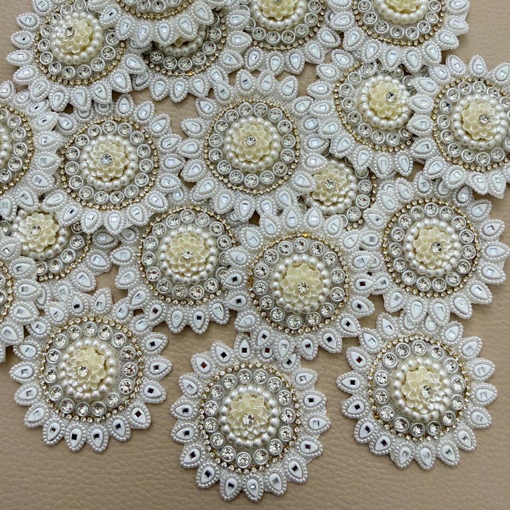 Round ivory and white floral patch beside a ruler showing approximately 6 cm diameter