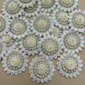 Round ivory and white floral patch beside a ruler showing approximately 6 cm diameter