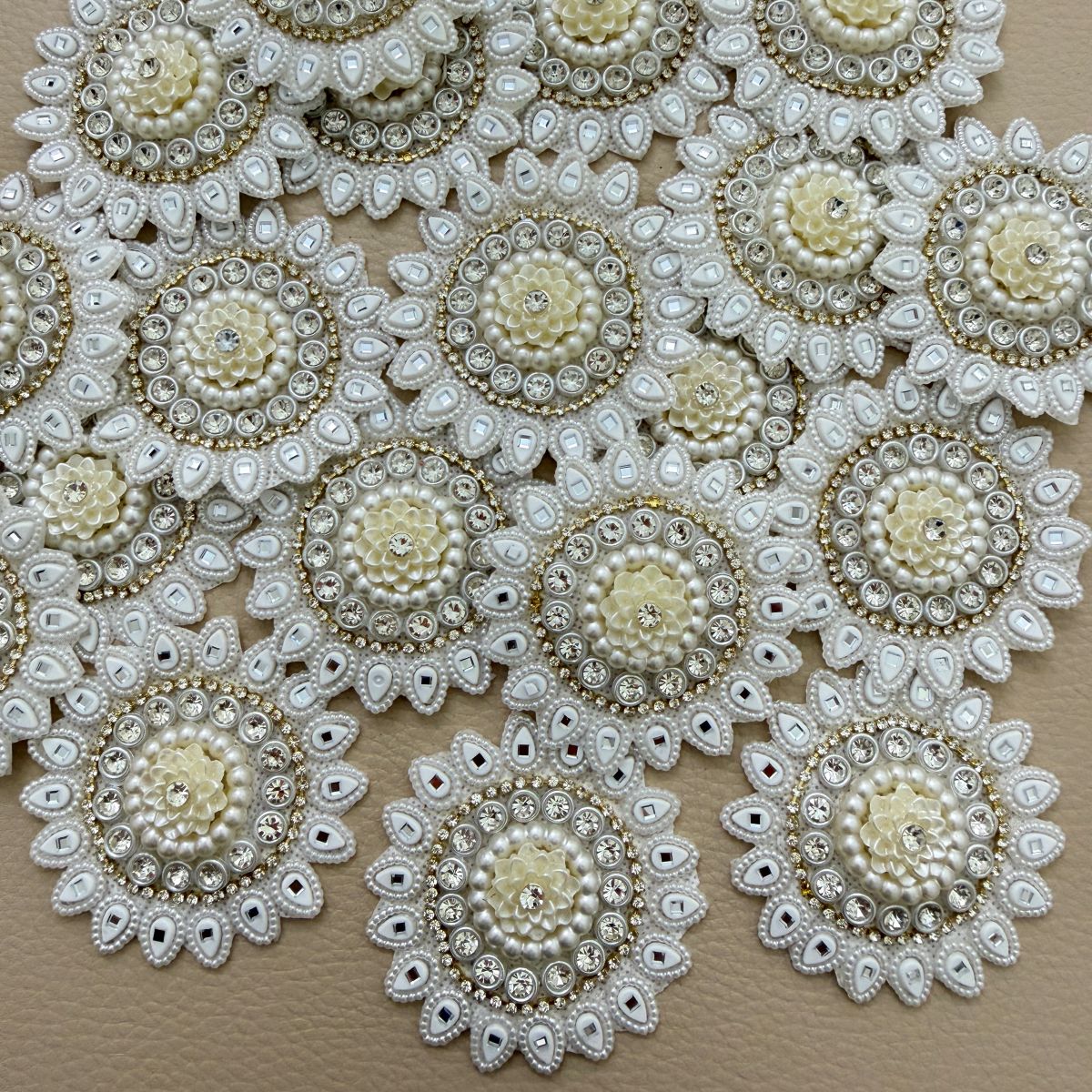 Round ivory and white floral patch beside a ruler showing approximately 6 cm diameter