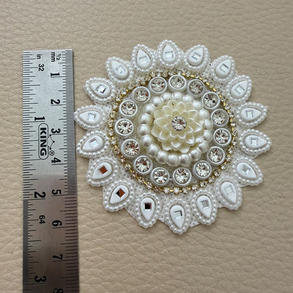 Front floral design and white mesh backing of round decorative patch