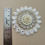 Front floral design and white mesh backing of round decorative patch