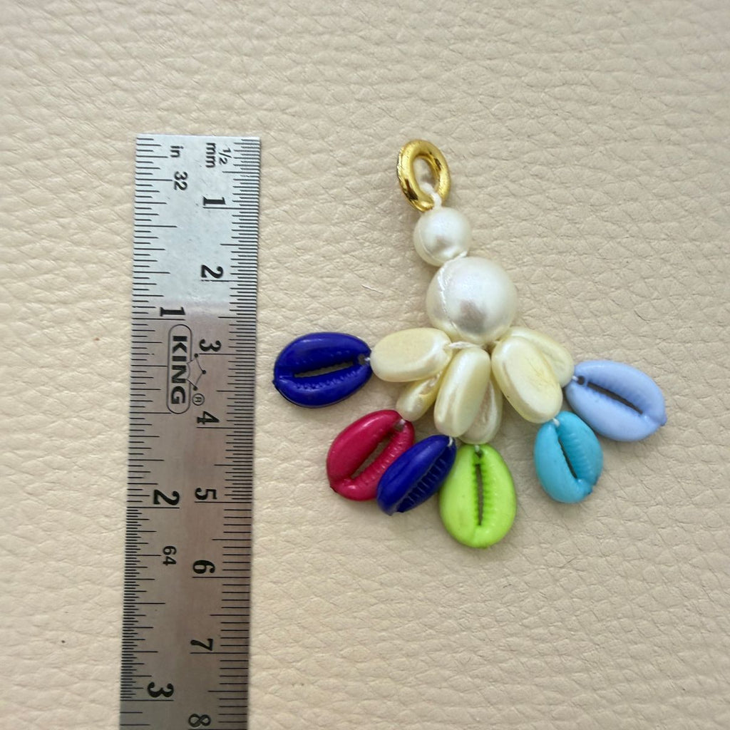 Kodi tassel beside a ruler showing approximate length