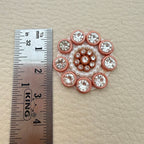 Flower applique beside ruler showing approximately 2.5 cm size