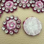 Pink flower rhinestone applique beside a ruler showing approximately 3 cm size