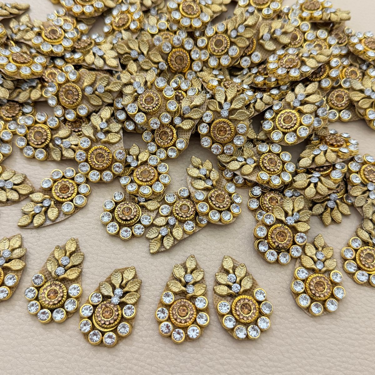 Group of gold-tone leaf and rhinestone teardrop appliques