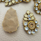 Front and beige mesh-style back of gold leaf rhinestone patch