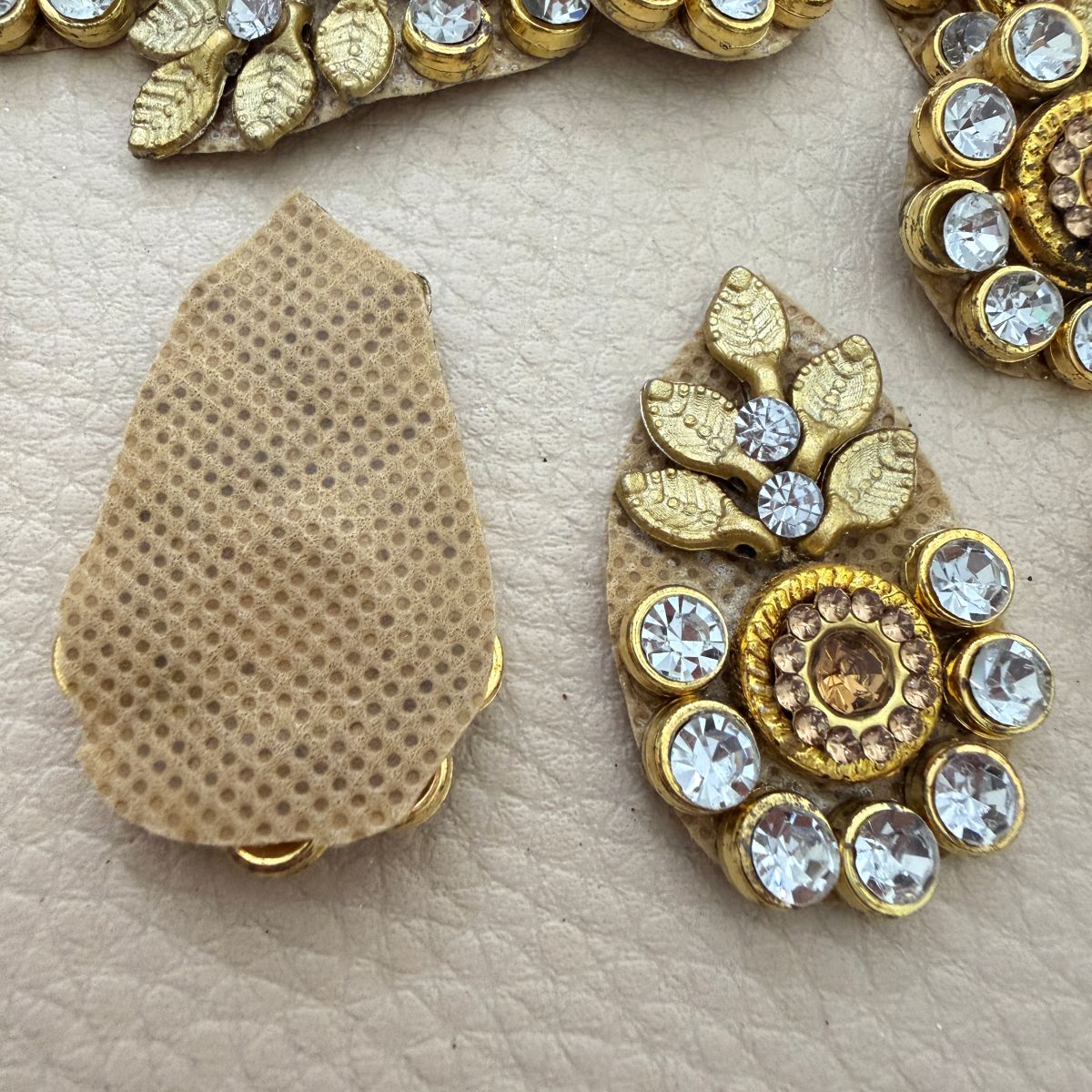 Front and beige mesh-style back of gold leaf rhinestone patch