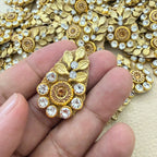 Gold leaf and rhinestone teardrop applique held in a hand