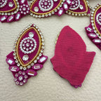 Close-up of pink applique rhinestones pearls and gold border