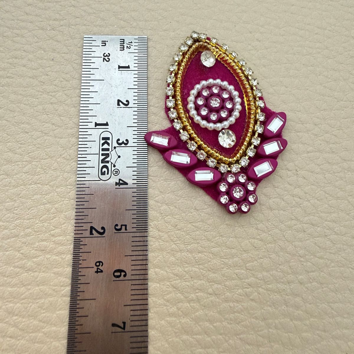 Pink teardrop applique beside ruler showing approximate length