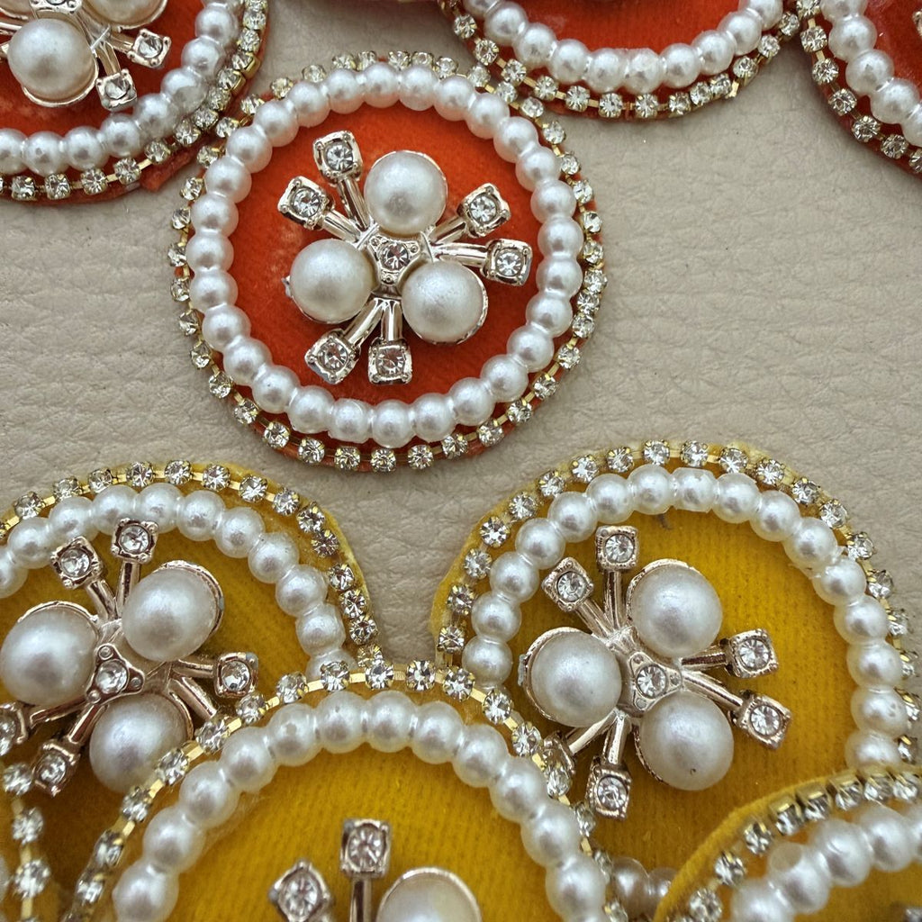 Yellow fabric patches with faux pearl floral centres and rhinestone borders