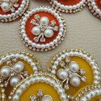 Yellow fabric patches with faux pearl floral centres and rhinestone borders