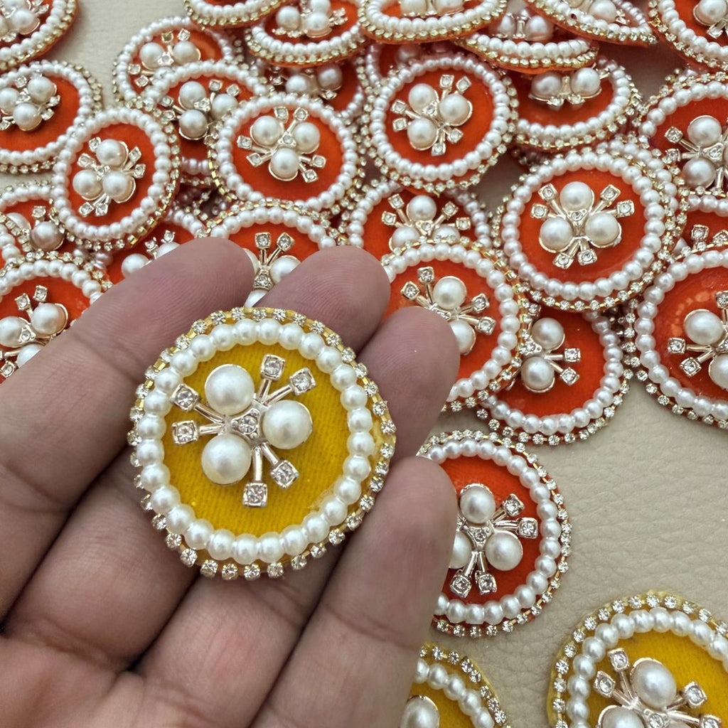 Close-up of orange and yellow pearl and rhinestone patches