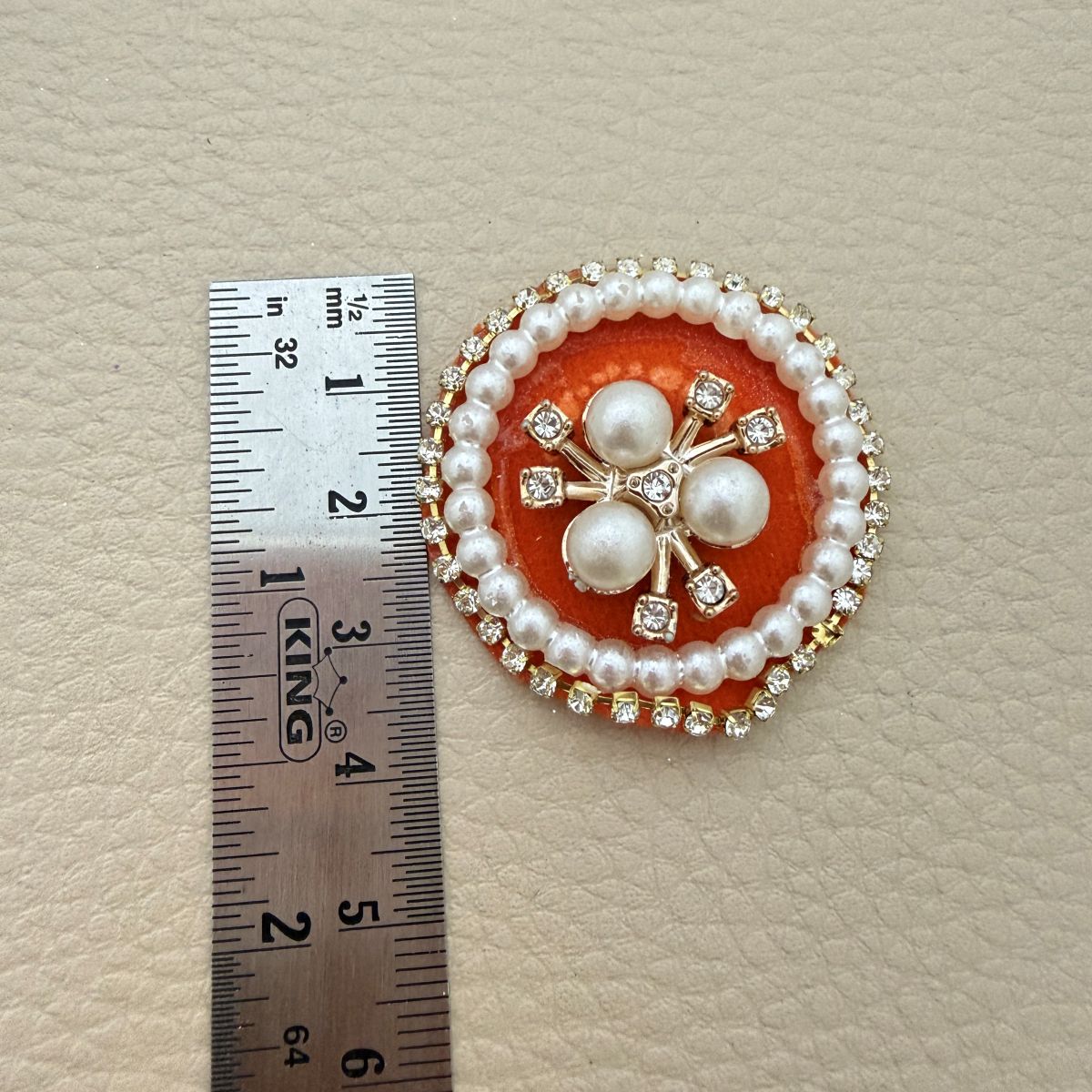 Orange round patch beside a ruler showing approximately 3.5 cm diameter