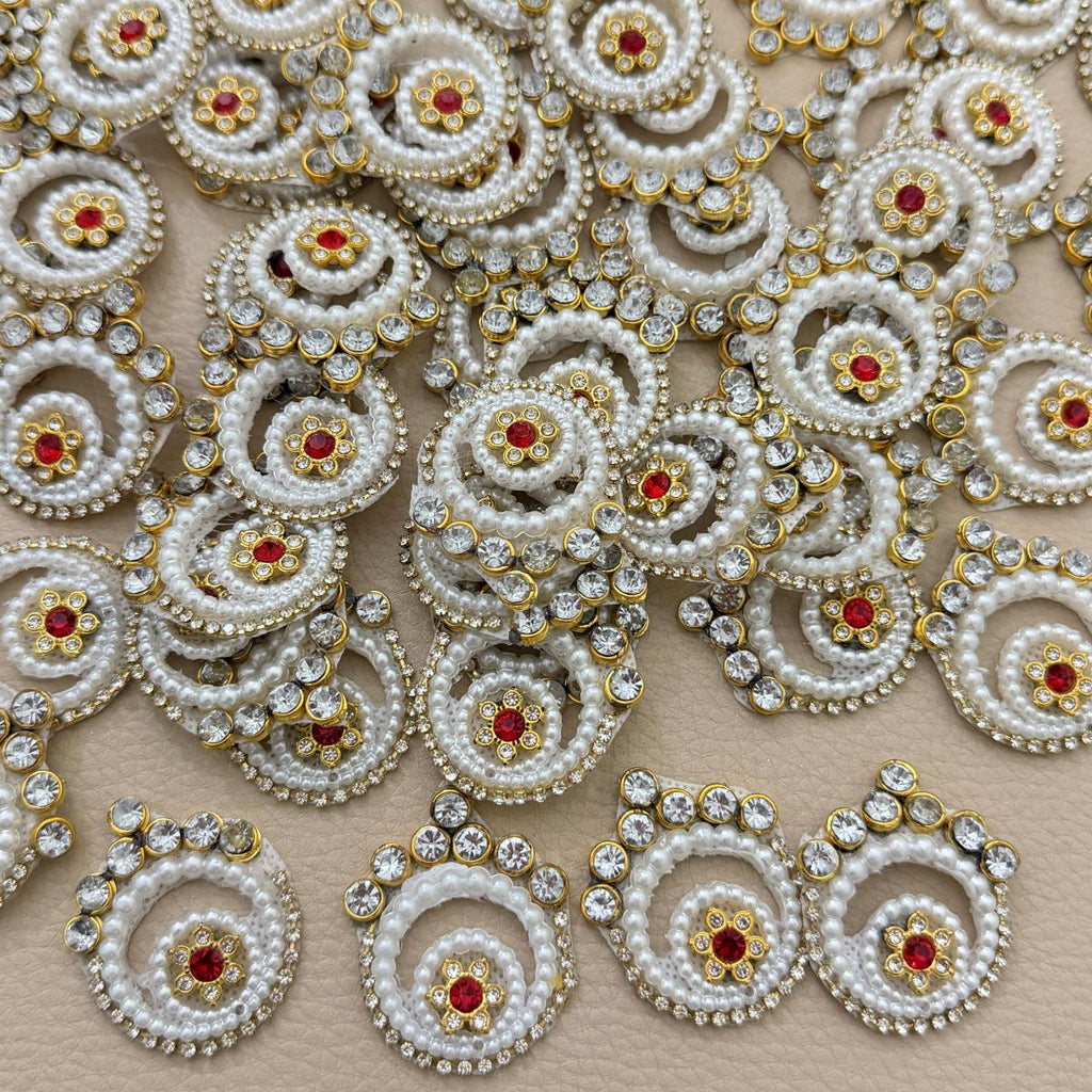 Collection of white pearl and rhinestone spiral patches with gold-tone settings