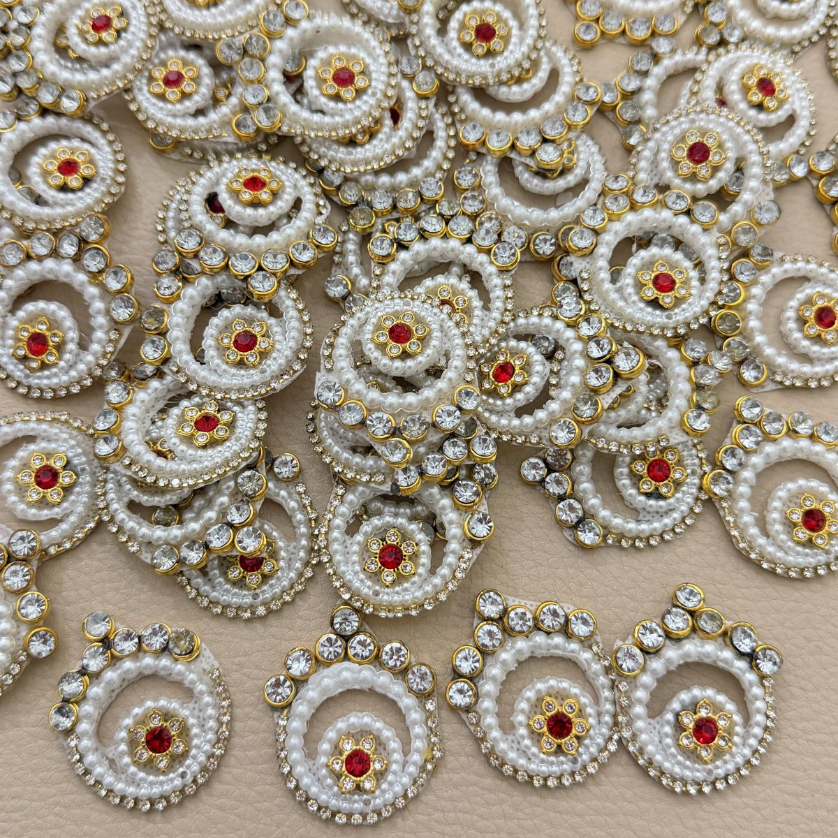 Collection of white pearl and rhinestone spiral patches with gold-tone settings