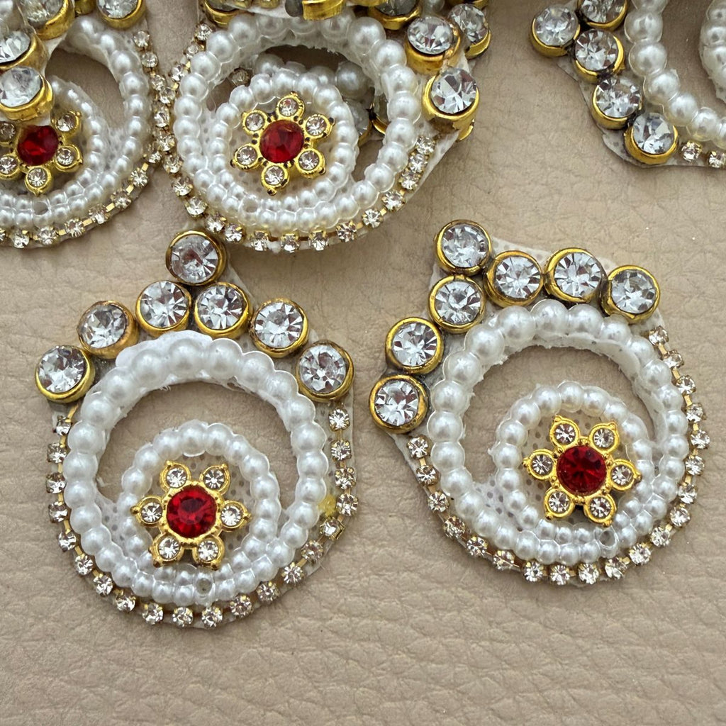 White pearl-look spiral patches with clear rhinestones and red floral centers