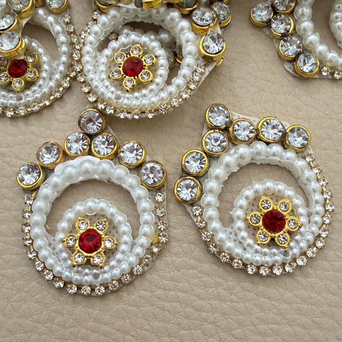 White pearl-look spiral patches with clear rhinestones and red floral centers