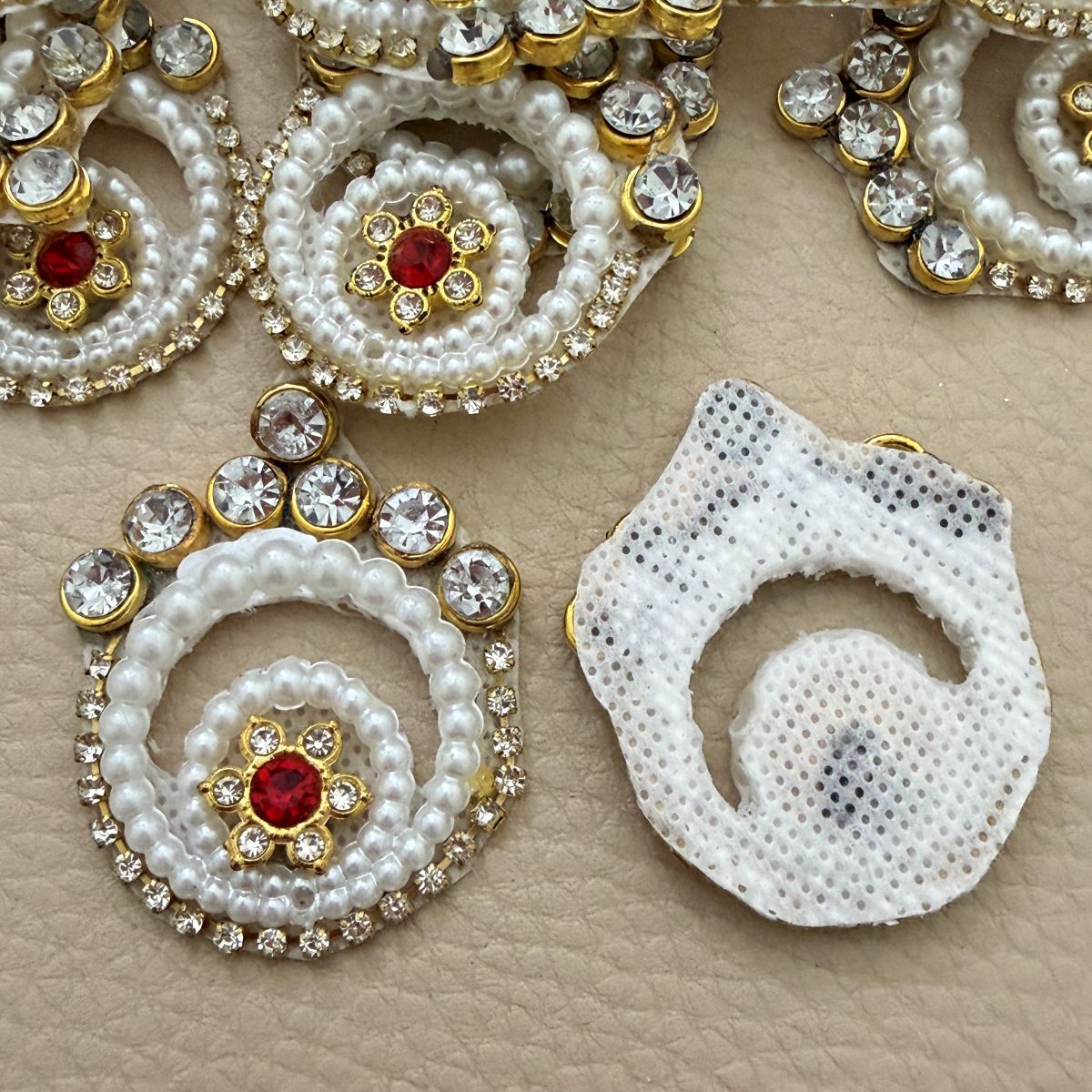 Front and white cut-out mesh backing of pearl spiral patch
