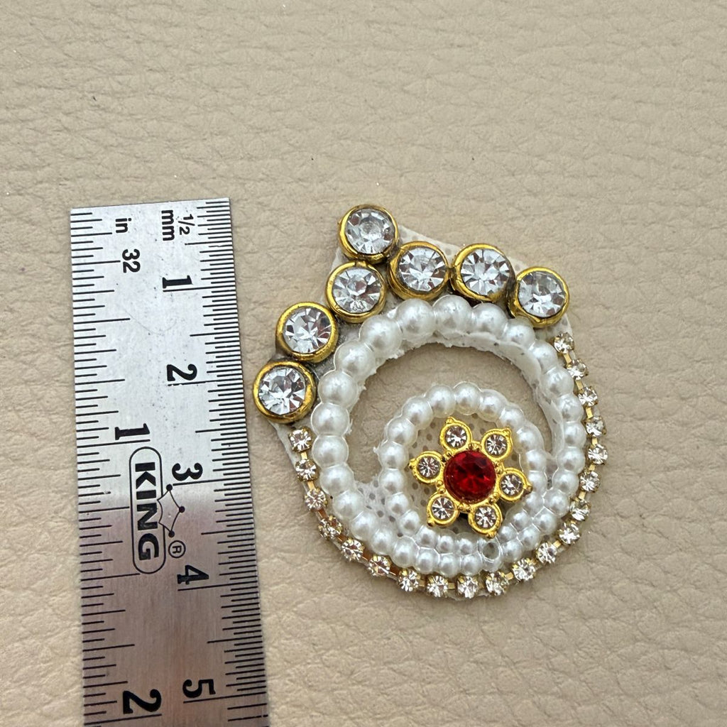 Pearl spiral patch beside ruler showing approximately 4 cm height