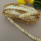 Decorative gold and silver trim on a neutral background